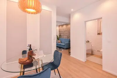 a dining room and living room with a glass table and chairs at Oporto lovely house deluxe in Porto