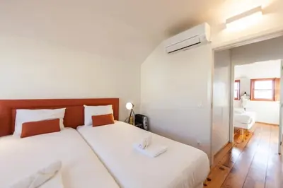 a bedroom with two beds with white sheets at Citybreak-apartments Douro View in Porto
