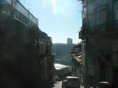 a city street with buildings and a river in the distance at Citybreak-apartments Douro View in Porto