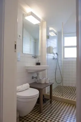 a bathroom with a toilet and a sink and a shower at Citybreak-apartments Douro View in Porto