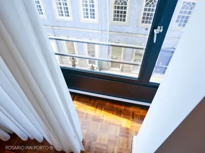 an open window with a view of a building at rosario inn porto in Porto