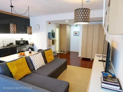 a living room with a couch and a table at rosario inn porto in Porto