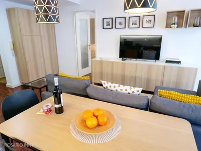 a table with a plate of oranges and a bottle of wine at rosario inn porto in Porto