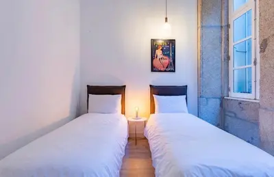 two beds sitting next to each other in a room at Porto Legend Apartments in Porto