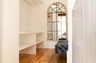 a dressing room with a chair and a mirror at Sky de Loios in Porto