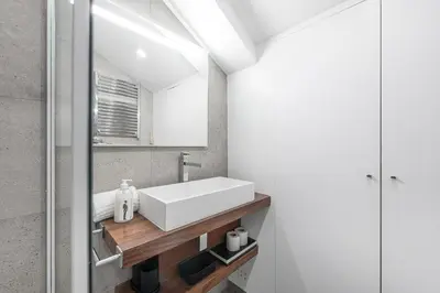 a bathroom with a white sink and a mirror at GuestReady - Chakra Duplex in Porto