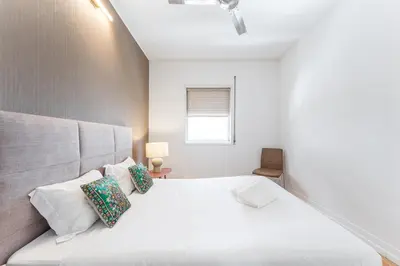 a bedroom with a white bed and a window at GuestReady - Riber Porto Apts in Porto