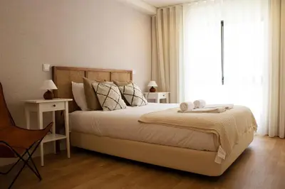 a bedroom with a large bed and a large window at Casa do Paraiso - City Center Gem (w/ AC) by LovelyStay in Porto