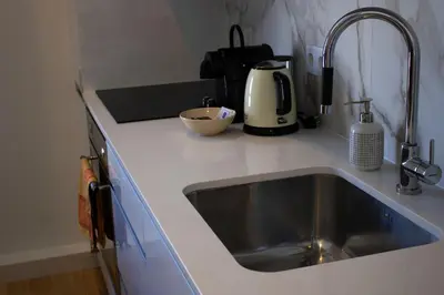 a kitchen counter with a sink and a mixer at Casa do Paraiso - City Center Gem (w/ AC) by LovelyStay in Porto