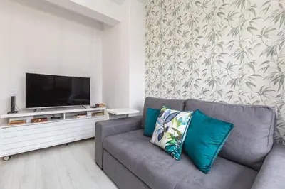 a living room with a couch and a flat screen tv at Apartamento Paradise Porto in Porto