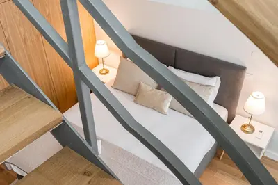 a small bedroom with a bed and two lamps at GuestReady - Porto by the Bridge in Vila Nova de Gaia