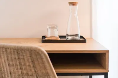 a vase and two glasses on a tray on a table at GuestReady - Porto by the Bridge in Vila Nova de Gaia