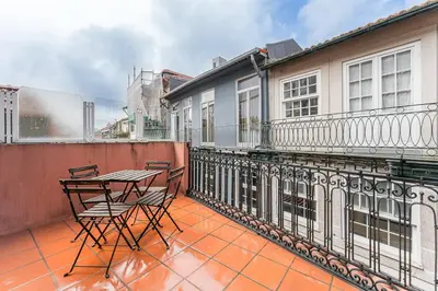 a patio with chairs and a table on a balcony at GuestReady - Final Step in Porto