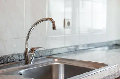 a stainless steel sink in a kitchen at GuestReady - Final Step in Porto