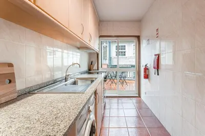 a kitchen with a sink and a large window at GuestReady - Final Step in Porto