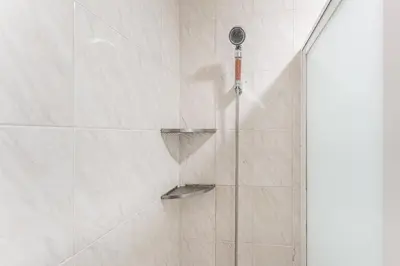 a shower with a glass door and a shower at GuestReady - Final Step in Porto