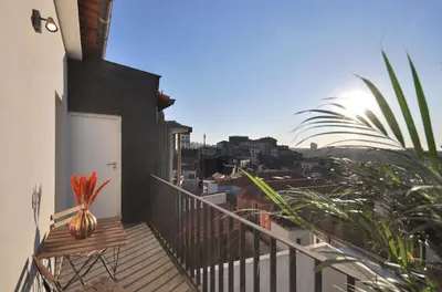 a balcony with a vase on top of a building at Sé do Porto - Loft with City View in Porto