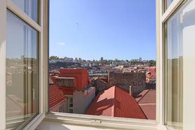 a view of a city from an open window at HM - Infante Riverside Apartment K in Porto