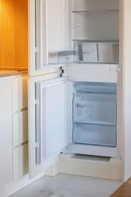 an empty refrigerator in a white kitchen at HM - Infante Riverside Apartment K in Porto