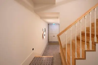 a hallway with stairs and a white door at HM - Infante Riverside Apartment K in Porto