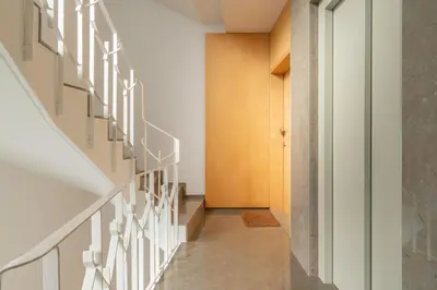 a staircase in a house with white railings at Host Wise - Restful Minimalist Flat - Balcony in Porto