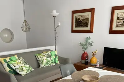 a living room with a couch and a television at Duplex Apt - Sleeps 4 - Roof Terrace - Balcony in Porto