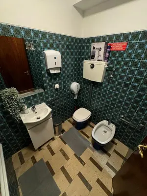 a bathroom with a toilet and a bidet and a sink at Pilar Hostel - Rua de Santa Catarina - Porto in Porto