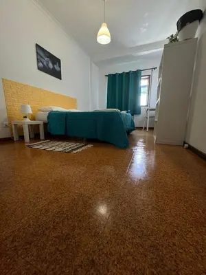 a bedroom with a bed with a blue sheet on it at Pilar Hostel - Rua de Santa Catarina - Porto in Porto
