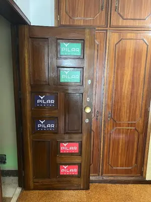 a wooden door with different signs on it at Pilar Hostel - Rua de Santa Catarina - Porto in Porto