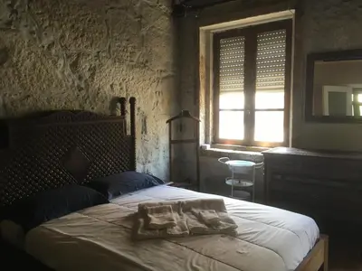 a bedroom with a bed in a room with a window at Vérités Dame in Porto
