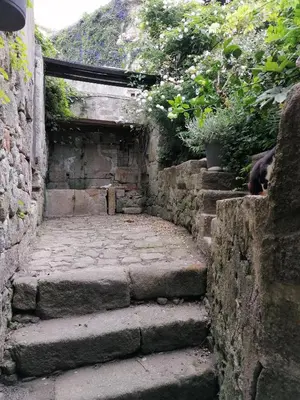 a stone wall with steps leading up to a building at Vérités Dame in Porto