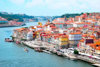 a city with buildings and a river with boats at CHARM APARTMENTS PORTO - Centro Batalha 2 in Porto