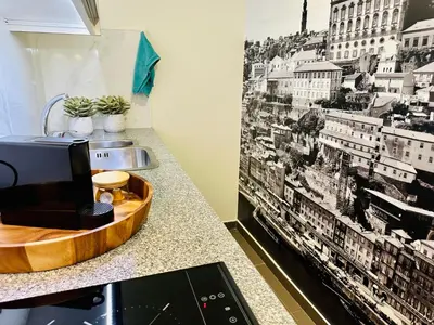 a kitchen with a black and white picture on the wall at CHARM APARTMENTS PORTO - Centro Batalha 2 in Porto