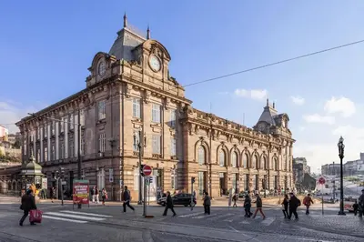 a large building with a clock tower on top of it at CHARM APARTMENTS PORTO - Centro Batalha 2 in Porto