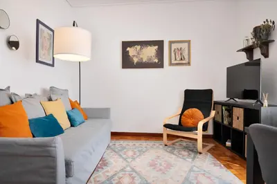 a living room with a couch and a chair at ! Luminous 2BR Top Floor ! Praça da República in Porto