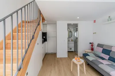 a living room with a couch and a staircase at Casa do Bonjardim, Lapa - Estadia no coração do Porto in Porto