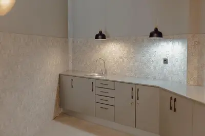a kitchen with a sink and a tile wall at River Eyes Suites in Vila Nova de Gaia