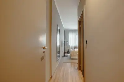 a hallway leading to a living room with a white door at River Eyes Suites in Vila Nova de Gaia