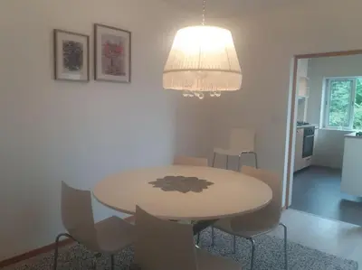 a dining room table with chairs and a chandelier at KrisApartments 2 in Porto