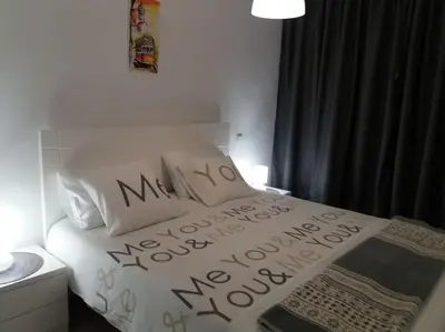 a bedroom with a bed with the words mama noelle mercy at KrisApartments 2 in Porto