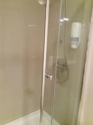 a shower in a bathroom with a glass door at KrisApartments 2 in Porto