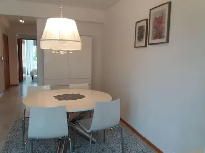 a dining room table with chairs and a chandelier at KrisApartments 2 in Porto