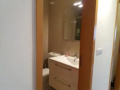 a bathroom with a sink and a toilet and a mirror at KrisApartments 2 in Porto