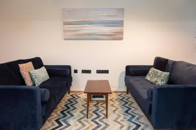 a living room with two blue couches and a table at Loungy Porto in Porto