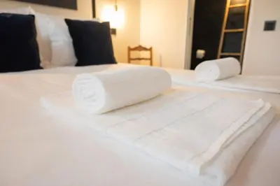 a pile of towels sitting on top of a bed at Loungy Porto in Porto