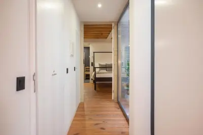 a hallway with white walls and wood floors at Loungy Porto in Porto