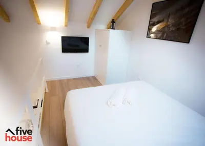 a bedroom with a large white bed in a room at FIVE HOUSE 16 in Porto