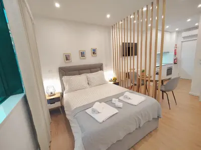 a bedroom with a bed with two white towels on it at A Window to Porto – Premium Apartment Porto Downtown in Porto