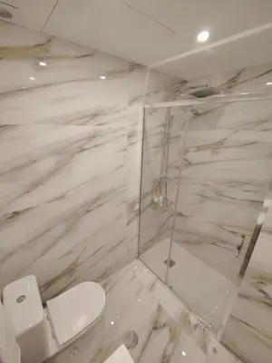 a bathroom with a toilet and a glass shower at A Window to Porto – Premium Apartment Porto Downtown in Porto