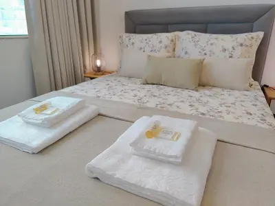 a bedroom with a bed with two towels on it at A Window to Porto – Premium Apartment Porto Downtown in Porto